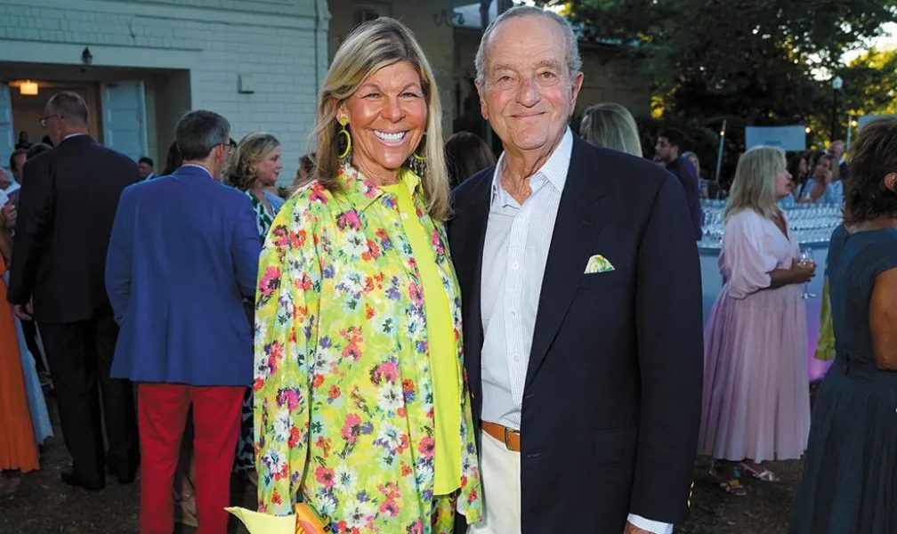 Couple smiling at a summer event.