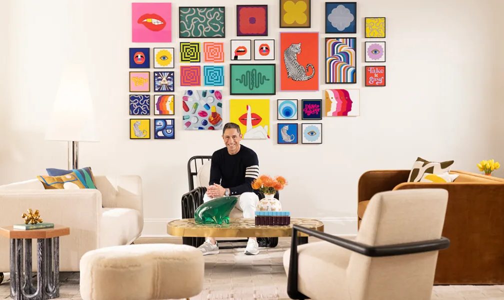 Man sitting in a living room with art.